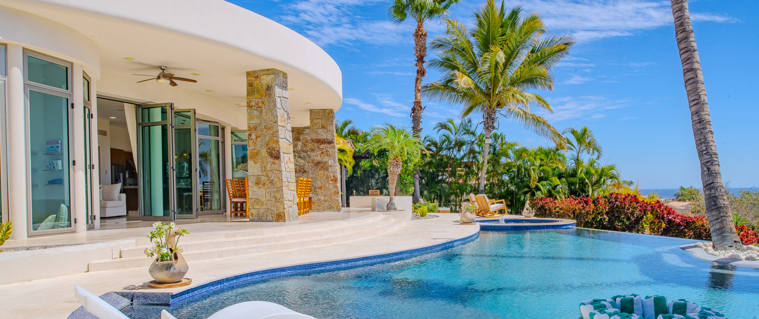 exterior of villa pool with lounge chairs